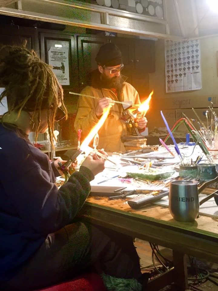 husband and wife glassblowing team at work